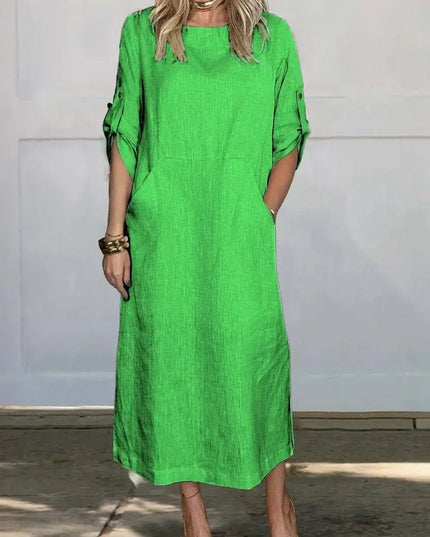 Bright green midi dress with pockets, rolled sleeves, and loose everyday silhouette
