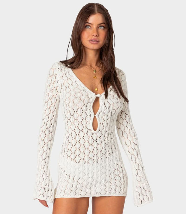 White crochet mini dress with tie front detail, long sleeves, and sheer lace texture