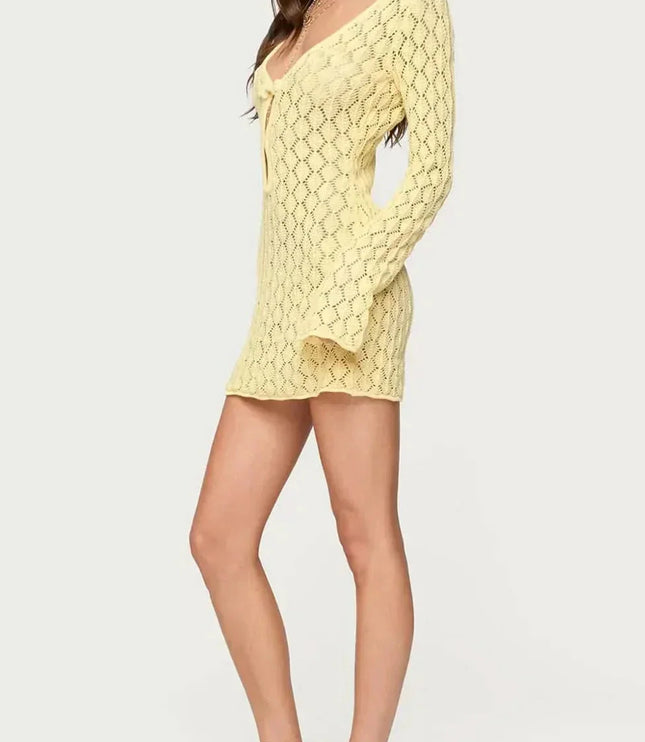 Side view of yellow crochet tie front mini dress with long sleeves and short hem