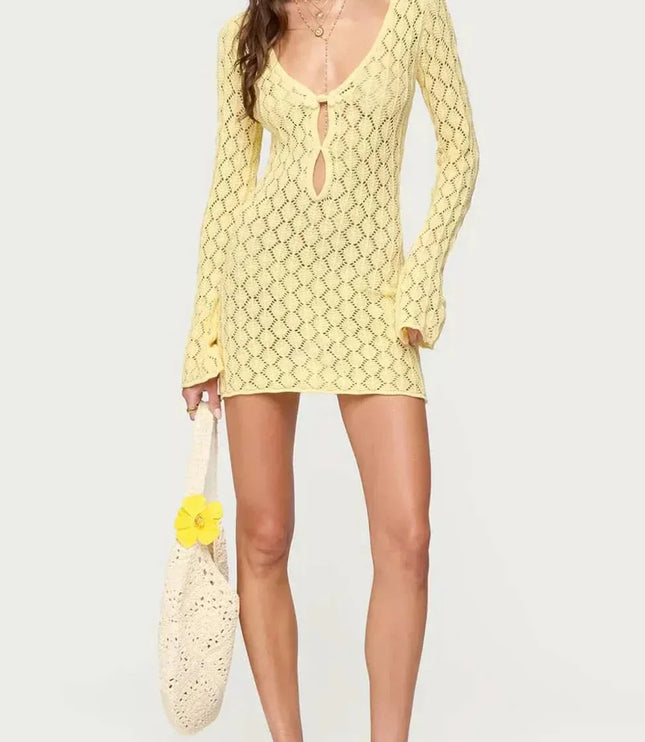 White crochet tie front mini dress with deep V neckline, long sleeves, and short hem