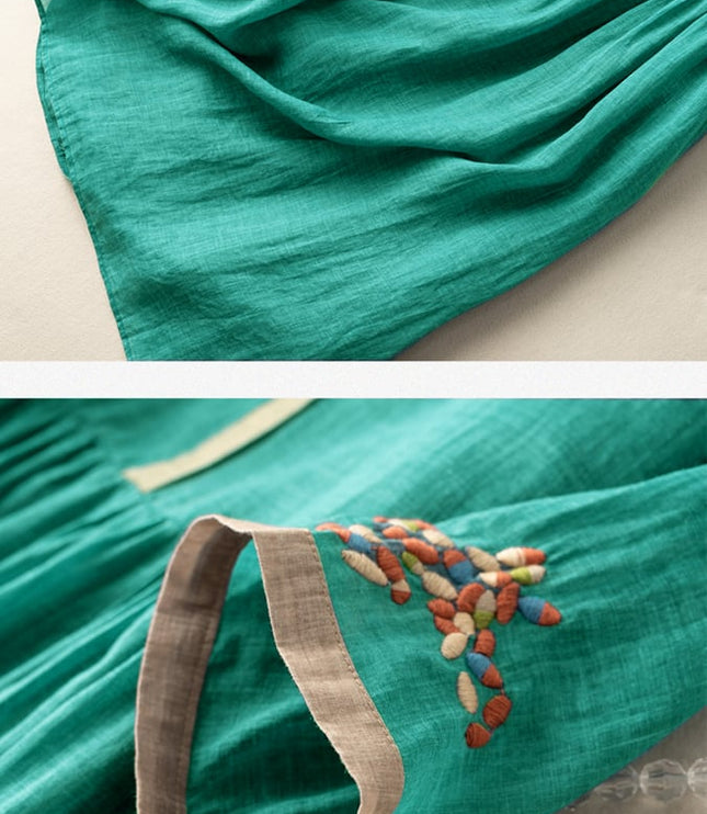 Close-up of teal summer dress showing embroidered sleeve cuff and lightweight fabric texture