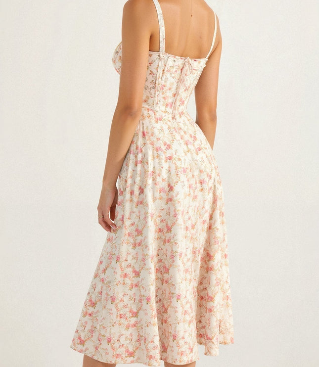 Back of white floral midi dress with pink rose pattern, showing the lace-up corset detail and flowing skirt.