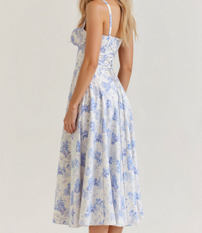 Rear view of white and blue floral midi dress, showcasing the lace-up back and elegant blue flower pattern.