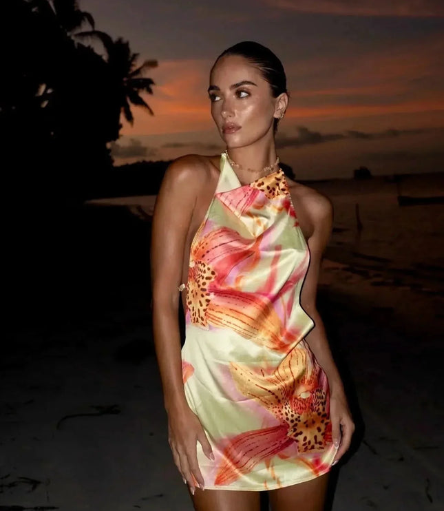 Back view of floral halter mini dress with open back and spaghetti straps