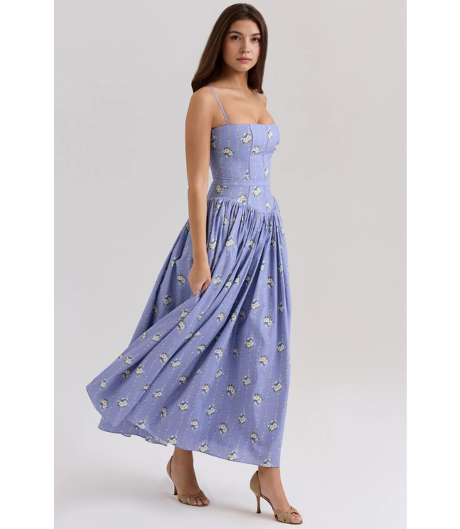 Side view of lavender floral summer dress with fitted waist and flowing midi length
