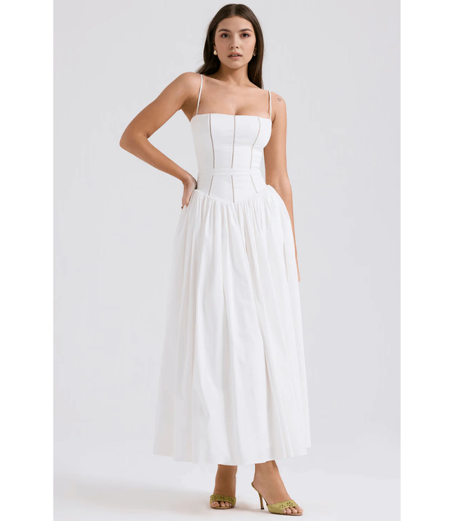 White floral maxi dress with spaghetti straps, fitted bodice, and flowing skirt