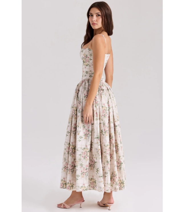 Side view of floral summer dress showing fitted waist and voluminous maxi skirt