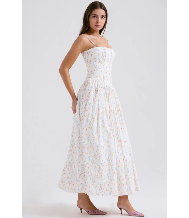 Side profile of white floral summer dress with corset bodice and ankle-length hem