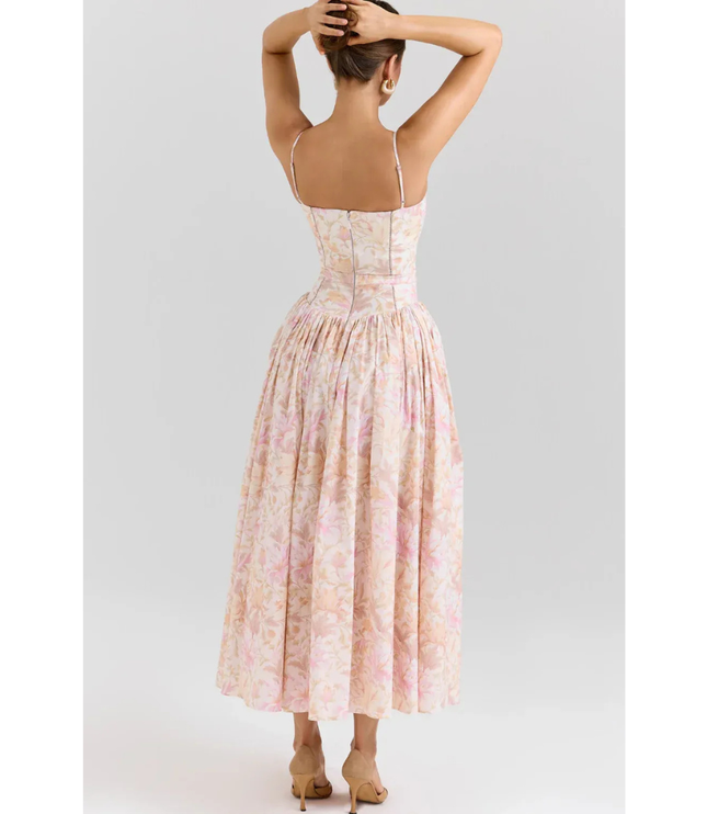 Side view of pastel floral summer dress with fitted bodice and full midi length skirt