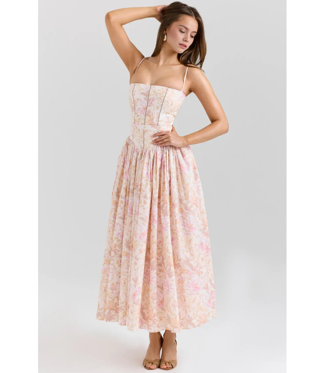 Women's floral maxi dress in pastel pink with straps, fitted bodice, and flowing skirt