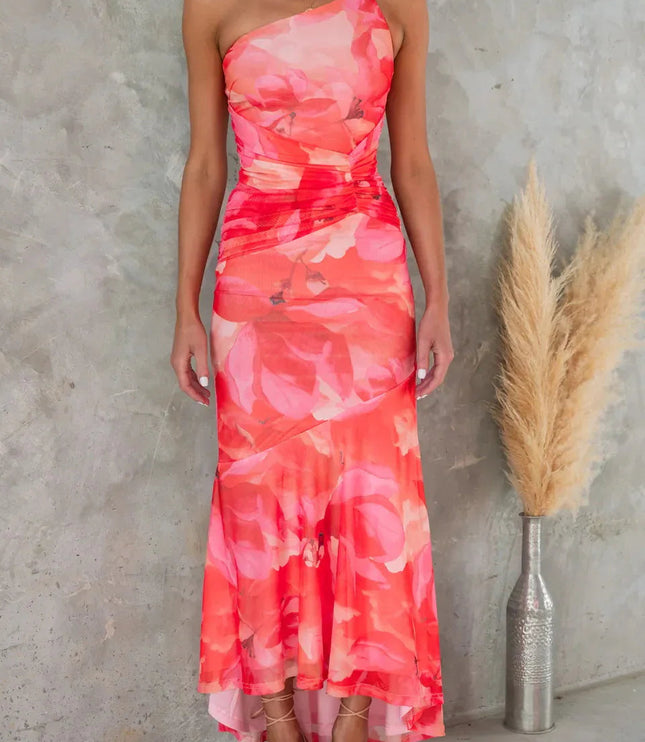 Coral pink floral midi dress with one shoulder neckline and flowing high-low skirt