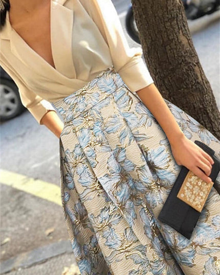 Close-up of embroidered blue and gold floral fabric with metallic details
