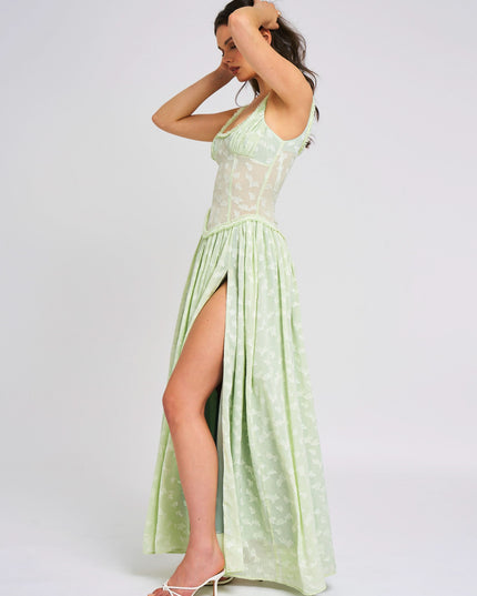 Side profile of pale green floral maxi dress showing draped neckline and leg slit