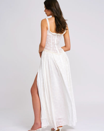 Back view of white maxi sundress with scoop neckline and flowing skirt