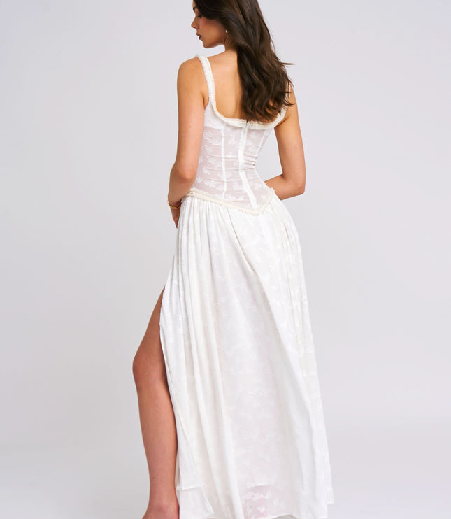 Back view of white maxi sundress with scoop neckline and flowing skirt