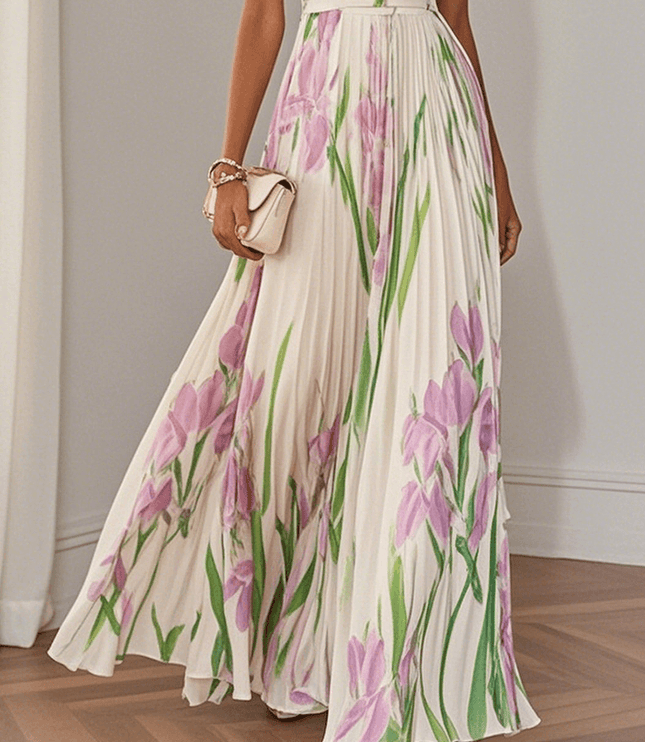Midsection view of women's summer floral maxi dress with pleated skirt and pink green botanical print
