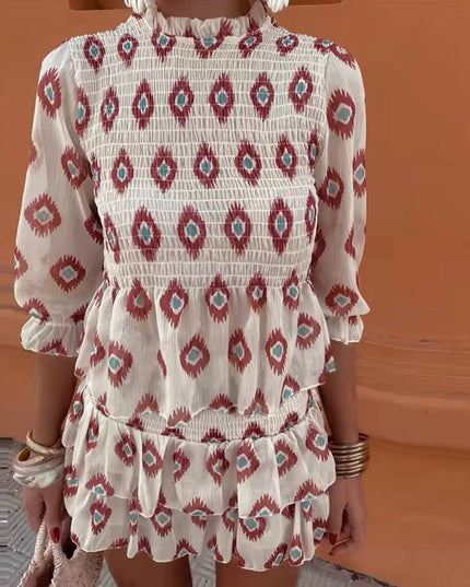 Close-up of floral long sleeve mini dress with smocked bodice and ruffle trim