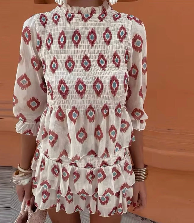 Close-up of floral long sleeve mini dress with smocked bodice and ruffle trim