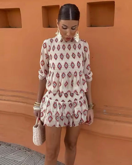 Front view of floral mini dress with long sleeves, smocked top, and tiered ruffles