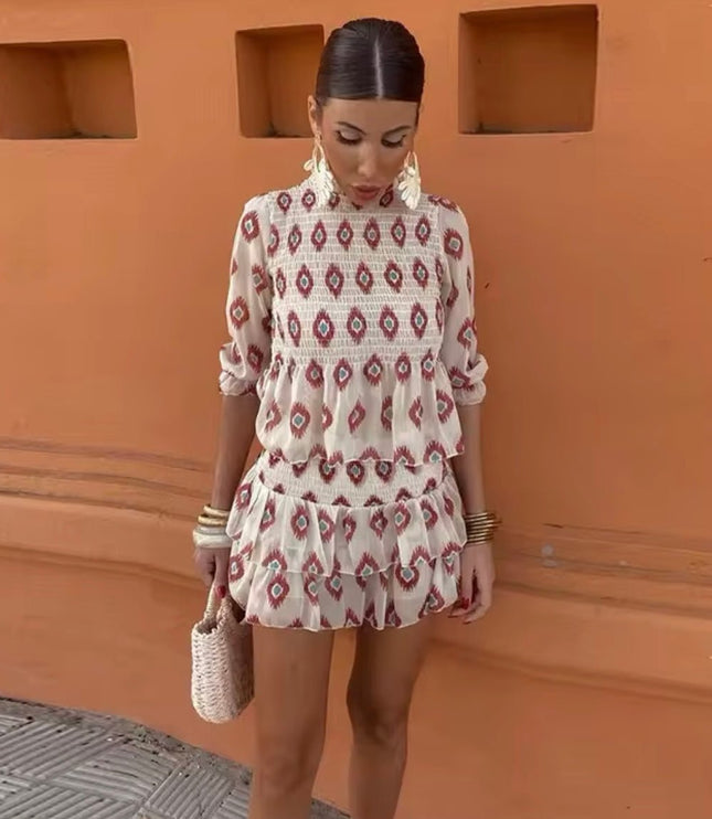 Front view of floral mini dress with long sleeves, smocked top, and tiered ruffles