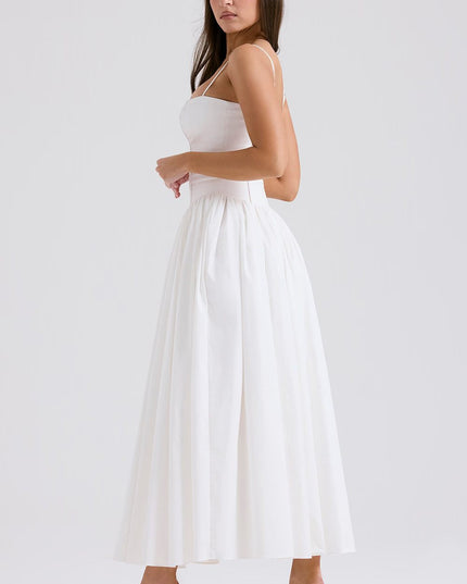 Side view of a women's white midi dress with spaghetti straps and a voluminous skirt, for a summer dress look.