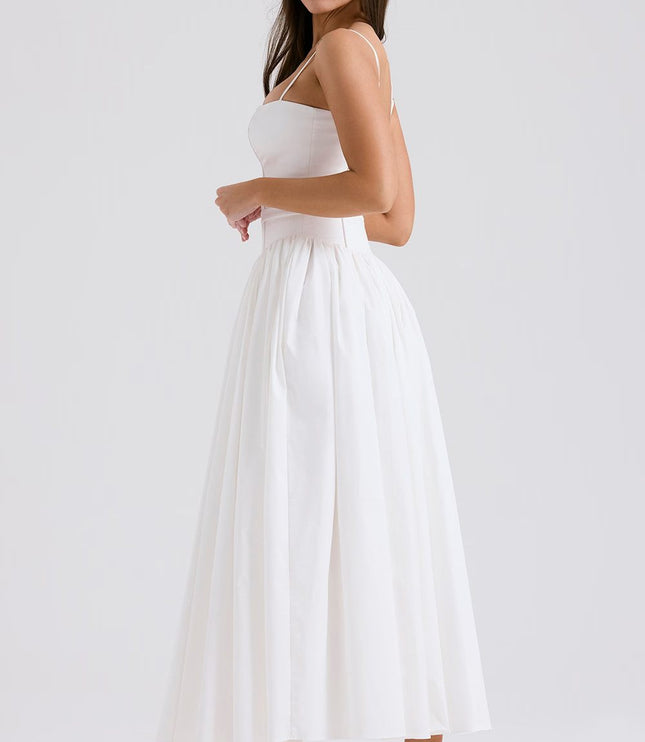 Side view of a women's white midi dress with spaghetti straps and a voluminous skirt, for a summer dress look.