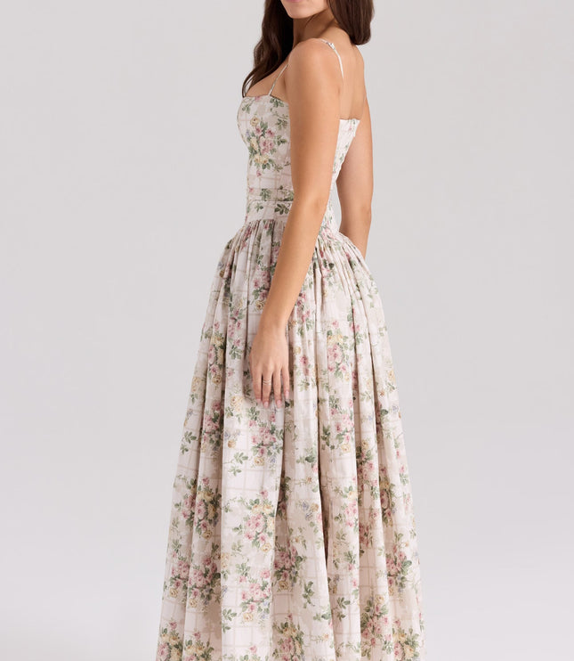 Back view of a women's floral midi dress in cream with pink and green flowers, highlighting the spaghetti straps and elegant silhouette.