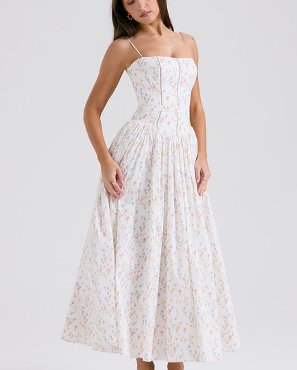 Side view of women's white summer floral midi dress with spaghetti straps and gathered skirt.