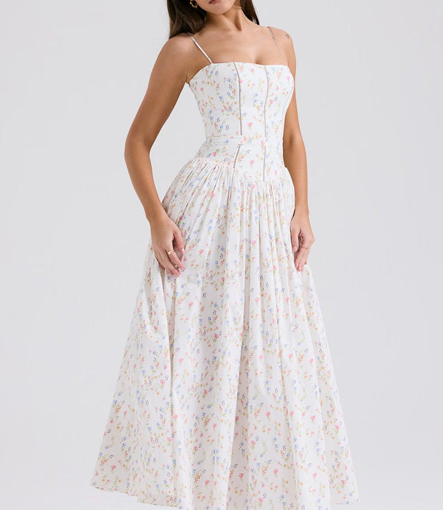 Side view of women's white summer floral midi dress with spaghetti straps and gathered skirt.
