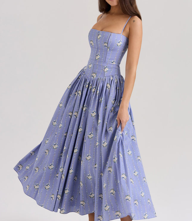 Side view of a women's periwinkle blue floral midi dress with spaghetti straps, showing the skirt gently swaying, ideal for a summer dress.