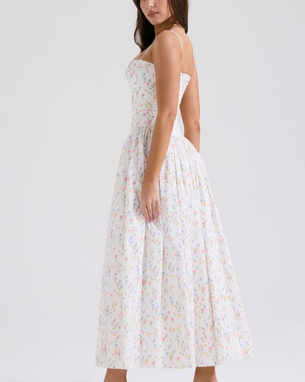Profile view of a white floral spaghetti strap midi dress, showcasing the full skirt and delicate print.