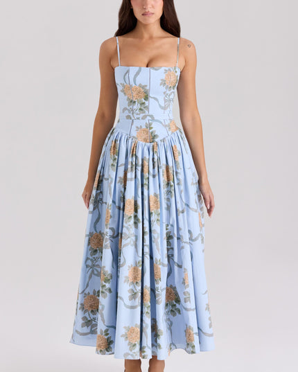 Front view of a light blue floral spaghetti strap midi dress with large orange rose patterns.