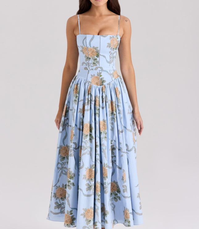 Front view of a light blue floral spaghetti strap midi dress with large orange rose patterns.