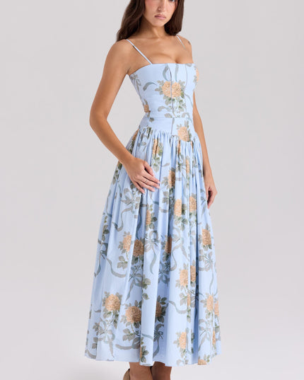 Angled view of a women's light blue floral midi dress with orange roses and ribbon details.