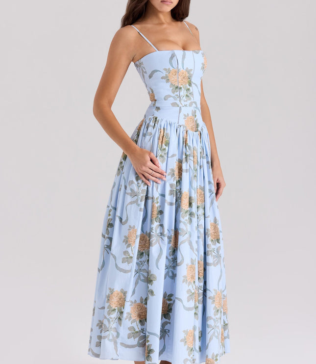 Angled view of a women's light blue floral midi dress with orange roses and ribbon details.