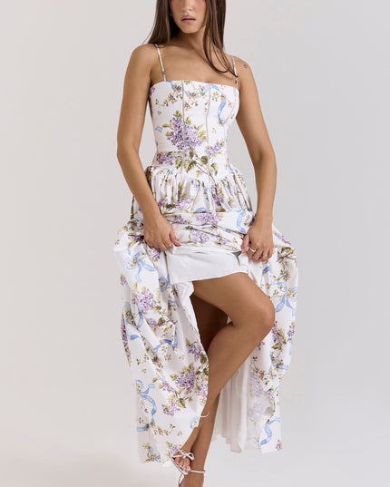 Women's white floral midi dress with spaghetti straps, showing a leg and the dress's inner lining.