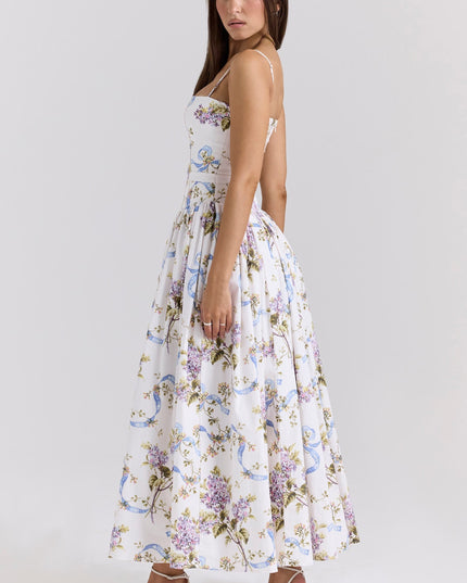 Side view of a white floral spaghetti strap midi dress with purple and blue patterns, showcasing the flowy skirt.