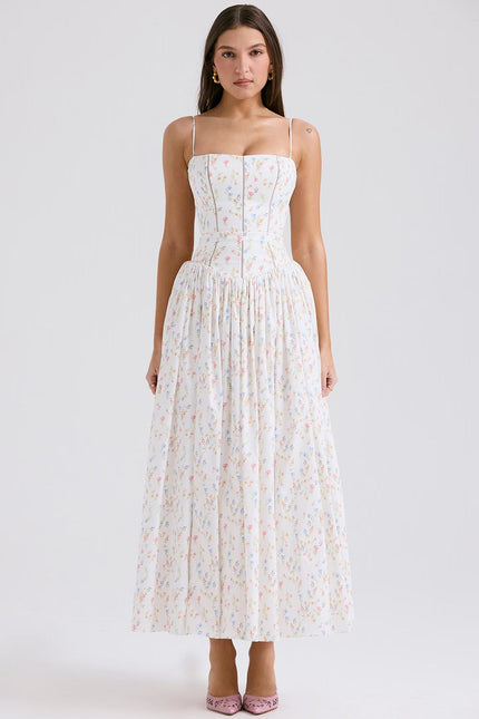 Full-length white floral spaghetti strap midi dress with delicate colorful flower print and fitted bodice.