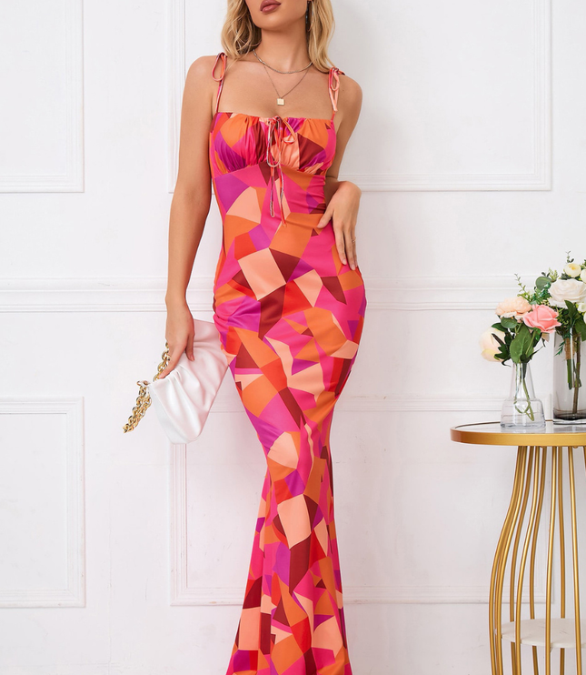 Front view of colorful geometric maxi dress with square neckline, tie straps, and fit