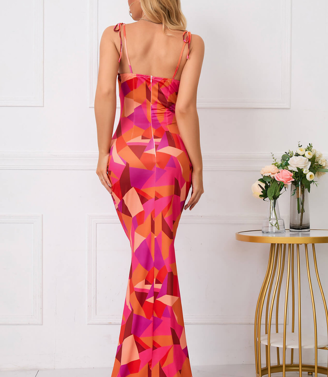 Back view of a pink and orange floral maxi dress with tie straps and fitted silhouette