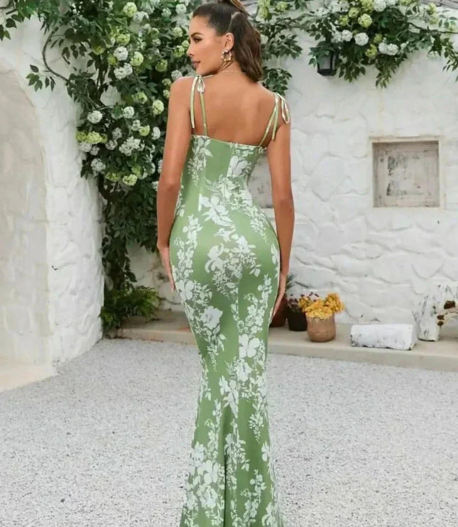 Back view of green floral maxi dress with open back, tie shoulder straps, and long fitted skirt