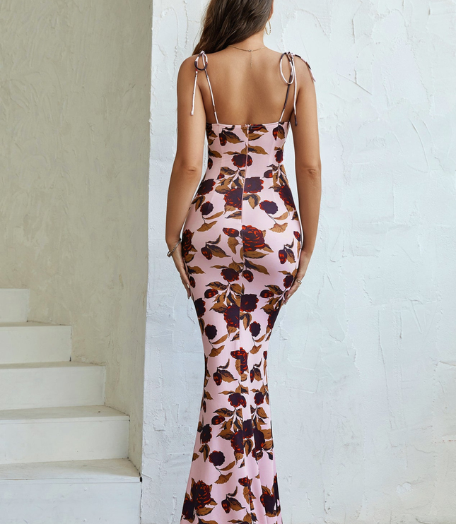 Back view of pink floral maxi dress showing open back, tie straps, and floor-length fit