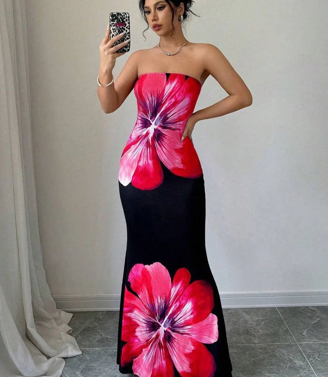 Woman in pink floral strapless maxi dress with black base and bold oversized blossom print