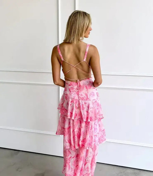 Back view of pink floral V neck maxi dress with crisscross straps and tiered skirt