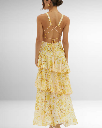 Back view of yellow floral maxi dress with crisscross straps and open back detail