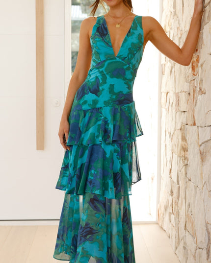 Front view of teal floral maxi dress with deep V neck and flowing tiered layers
