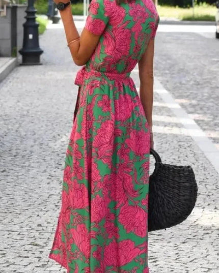 Back view of floral midi dress with pink and green pattern, short sleeves, and flowing skirt