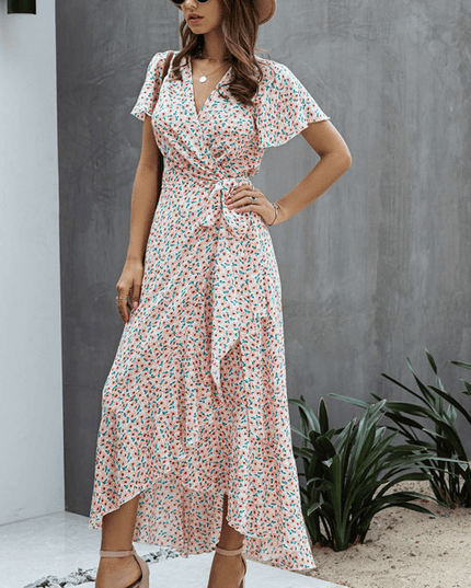 Pink floral wrap midi dress with V neck, flutter sleeves, and side tie detail