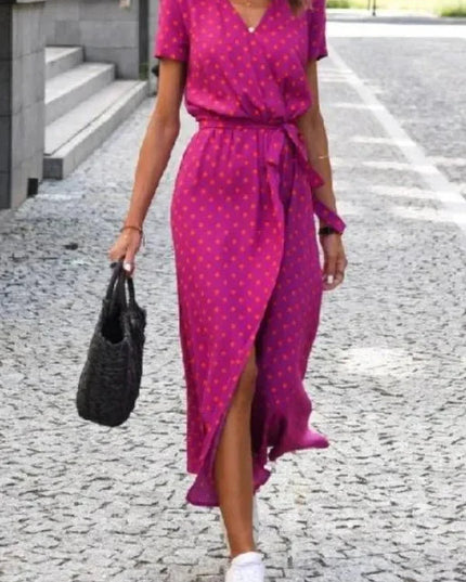Front view of a magenta polka dot midi dress with V neck, short sleeves and wrap skirt