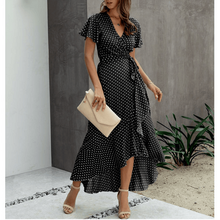 Black polka dot V neck midi dress with flutter sleeves, wrap waist tie, and asymmetrical hem